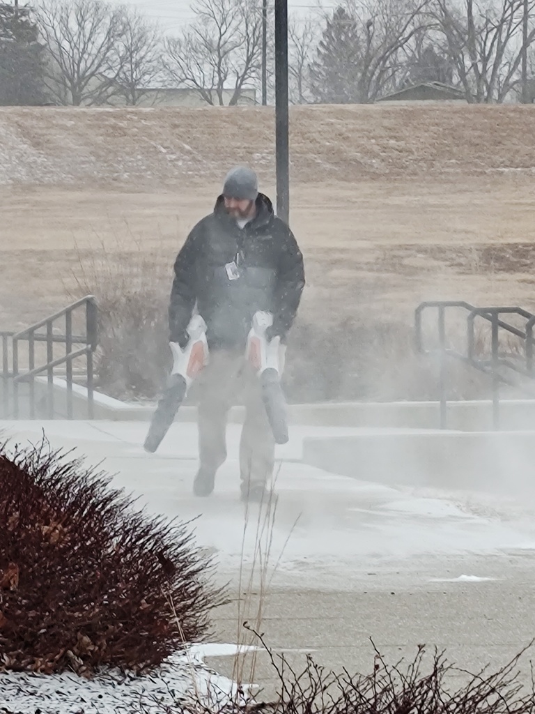 Bud Young, CCCHS principal, clearing snowy sidewalks.